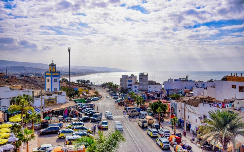 Taghazout coastline with fishing boats, seaside buildings and local market stalls
